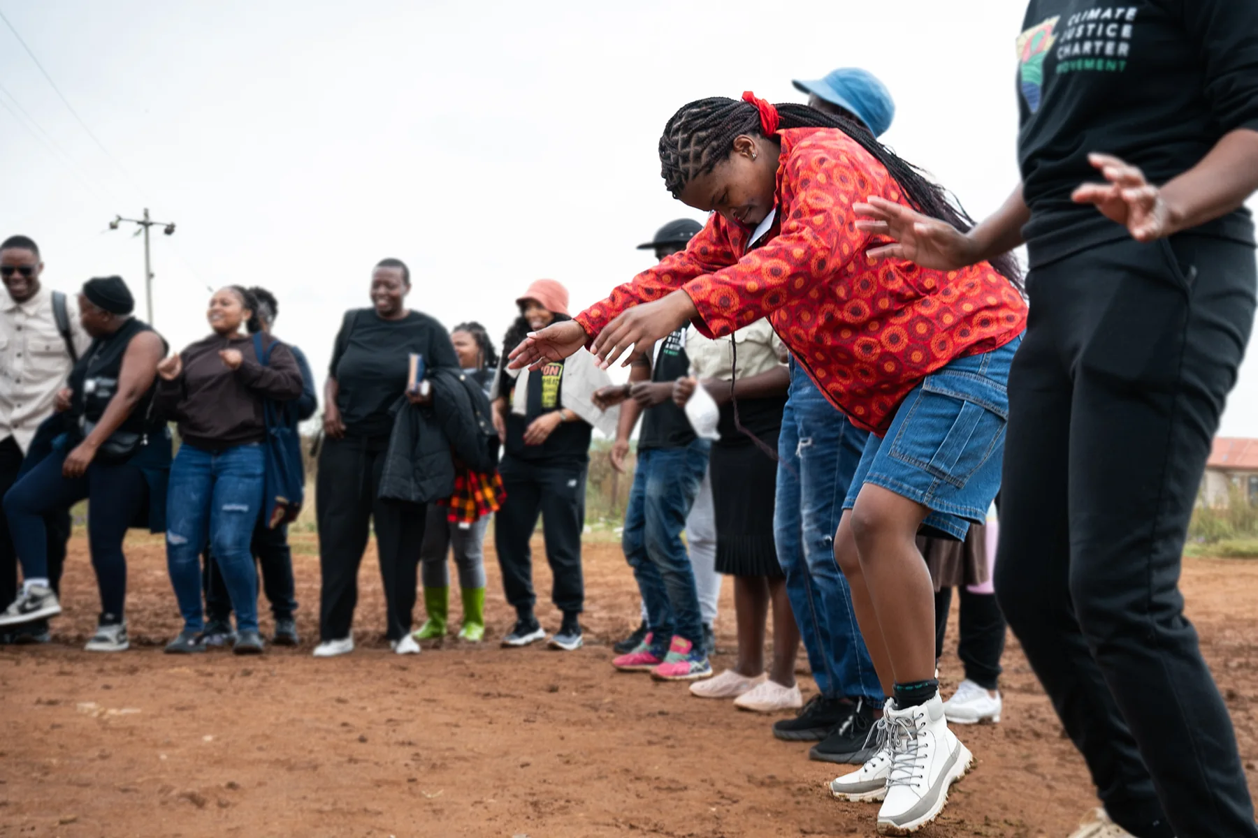 Women participating in an outdoor movement-building activity at a JASS gathering